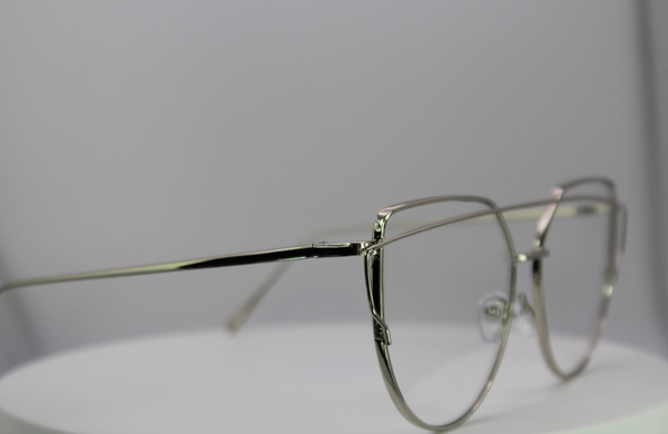Silver eyeglasses on a light gray background