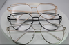 Three pairs of Detroit brand Bellz Coutre eyeglasses with different frame colors on a white background