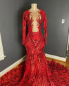 red sequin gown with deep v and swirl embellishments on mannequin against a dark wall by Bellz Couture in Detroit