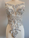 Silver beaded top on a mannequin with a plain background