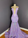A lavender and iridescent sequin mesh gown with a deep neckline and a mermaid train, displayed on a mannequin by Bellz Couture in Detroit.