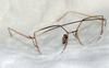 Gold-framed eyeglasses on a white background