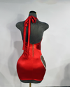 back view of red halter dress with heart side cutout trimmed in silver rhinestones by Bellz Couture Detroit on a mannequin against a plain wall