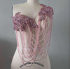 pink applique beaded and chain shoulder piece on a mannequin with 'Collapsible Shoulder' label. Bellz Couture Detroit 