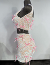 side view of A two-piece outfit with a sequined tank top and a matching mini skirt, both adorned with pink ribbon bows and rhinestone accents by Bellz Couture of Detroitdisplayed on a mannequin.