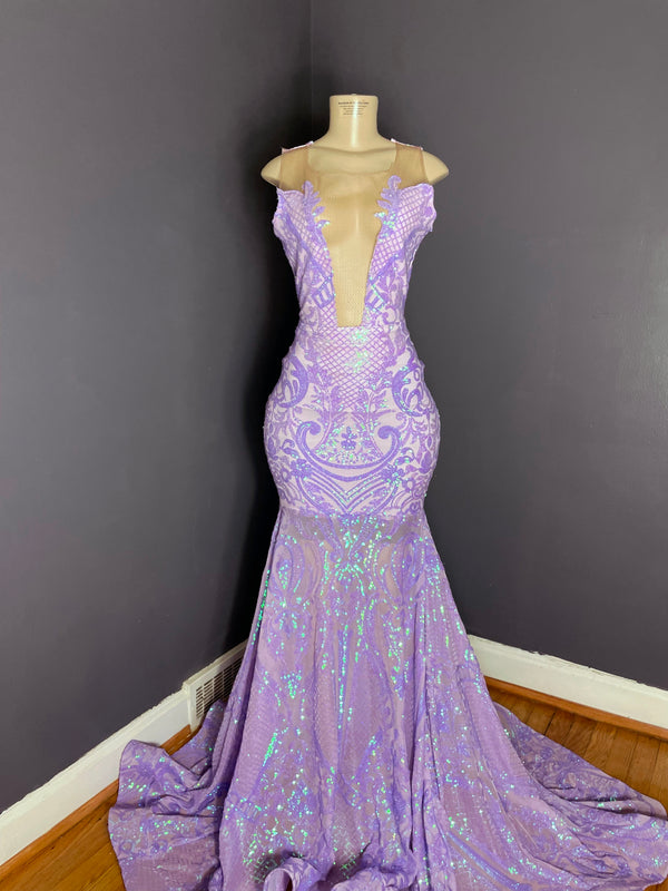 A lavender and iridescent sequin mesh gown with a deep neckline and a mermaid train, displayed on a mannequin by Bellz Couture in Detroit.
